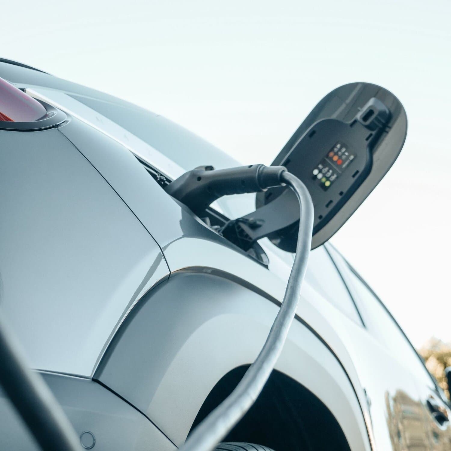 Electric car plugged in at charging station